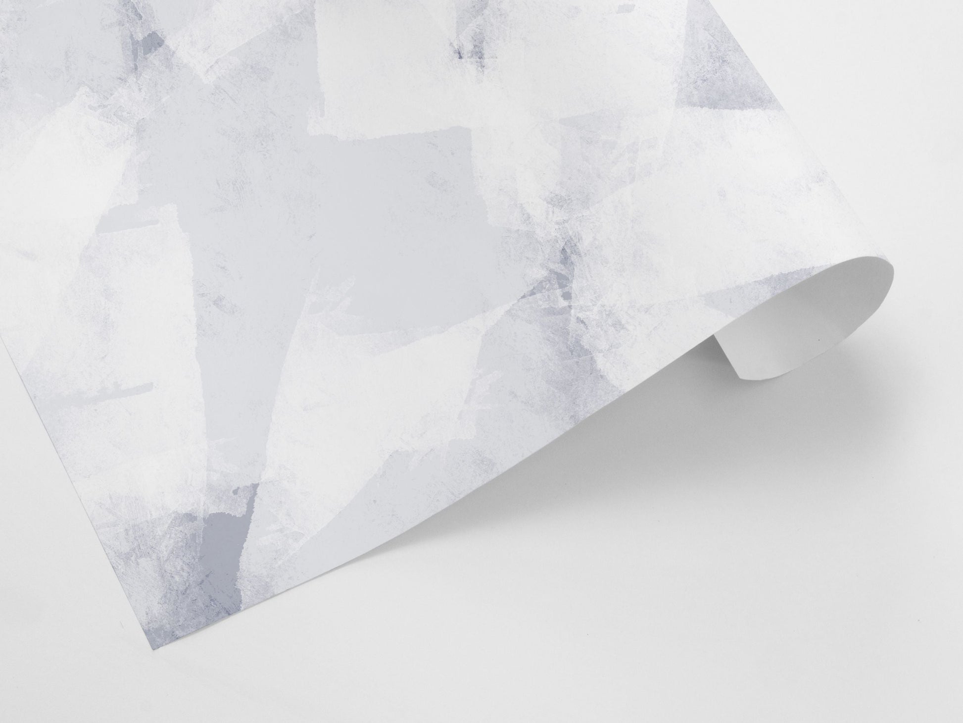 A gift wrap sheet with an abstract geometric pattern in blue and white tones.