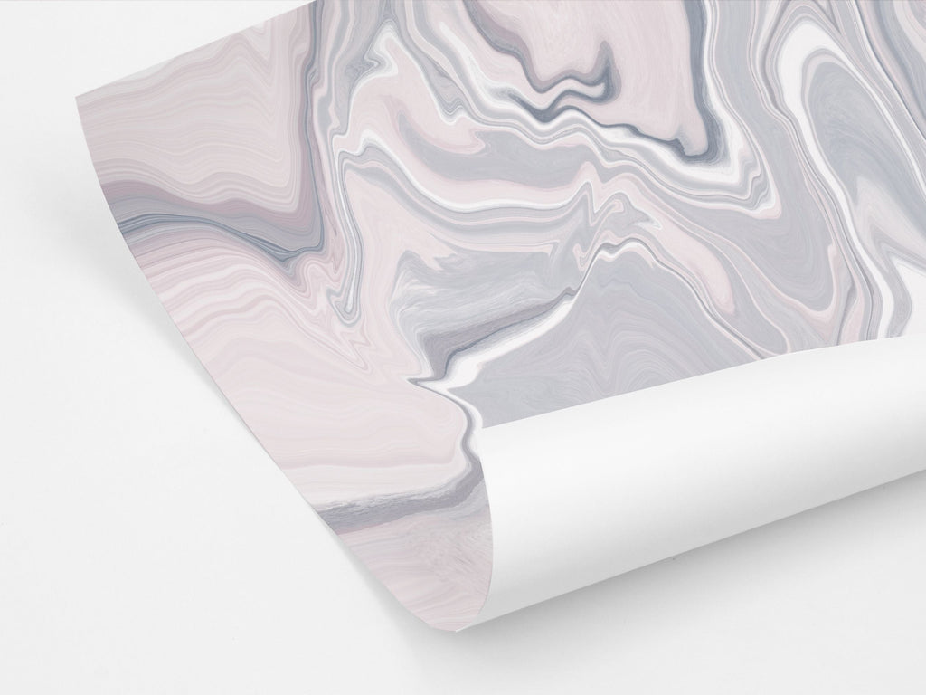 A sheet of gift wrapping paper featuring an abstract marble pattern in pink and grey tones.