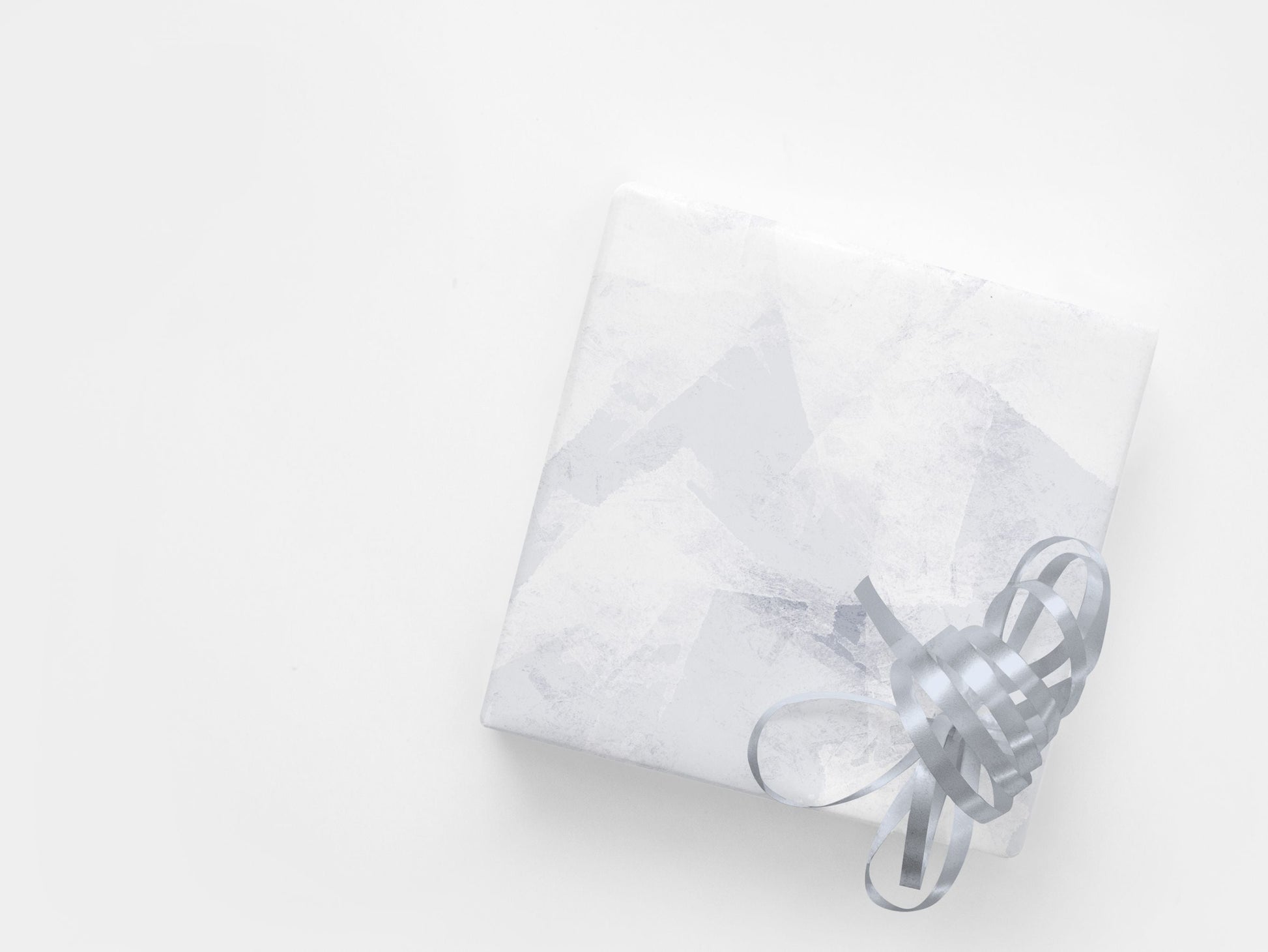 A gift wrapped in a subtle abstract paper in blue and white tones
