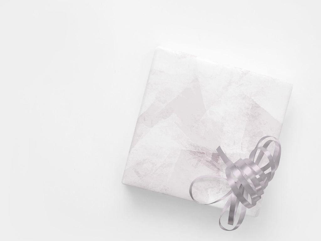 A wrapped present featuring soft pink abstract gift wrap
