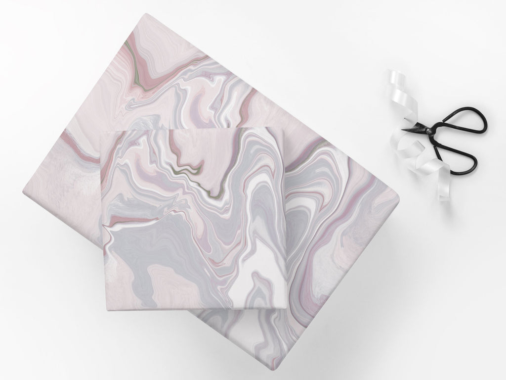 Gifts wrapped in an abstract marble pattern in pink tones.