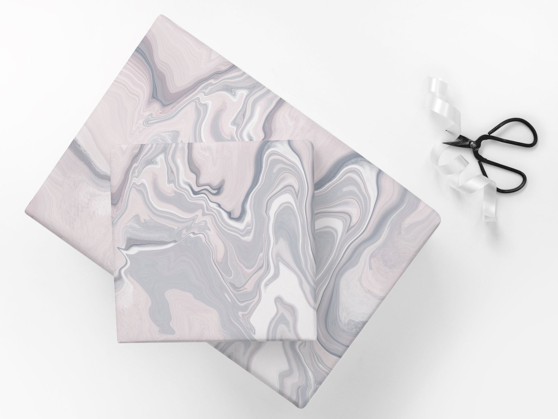 Gifts wrapped with paper featuring an abstract marble pattern in pink and grey tones.