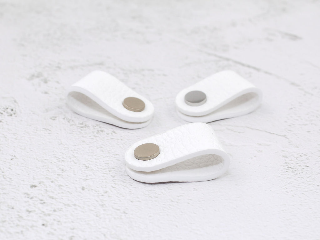 Set of 3 white pebbled-grain faux leather cord wraps with a snap closure, displayed on a textured background.